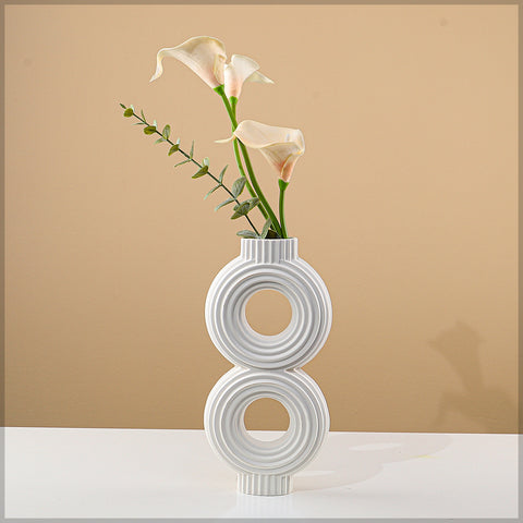 White ceramic vase with ribbed texture for living room styling