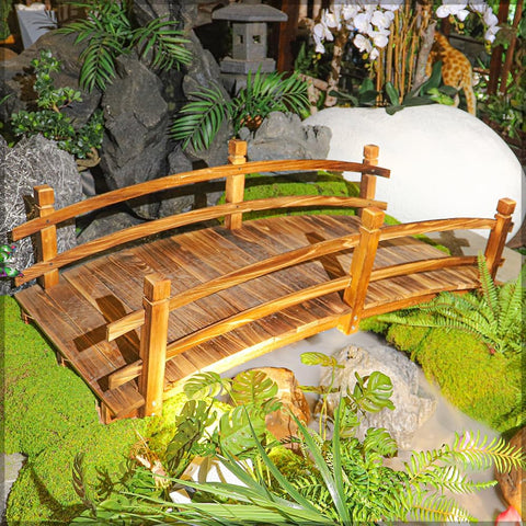 Sturdy solid wooden arch footbridge with safety handrails and a beautiful arched frame