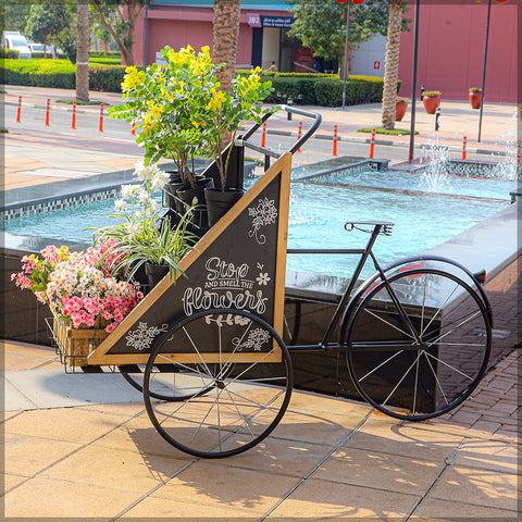 Elegant metal bicycle planter with a spacious design for displaying flowers or plants