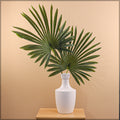 Fake indoor palm trees with decorative fan palm leaves