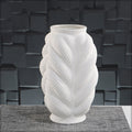 Sculptural ceramic vase with braided whirl pattern