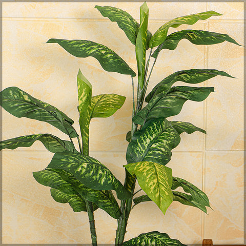 Fake dieffenbachia plant for home decor placed in a decorative pot