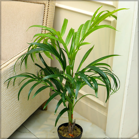 Decorative artificial green palm plant in a stylish pot