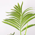 Durable fake palm leaves in a decorative pot for realistic charm