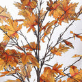 Lifelike artificial maple leaves with vibrant orange tones for autumn ambiance