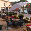 Cantilever hanging umbrella providing shade in a garden setting