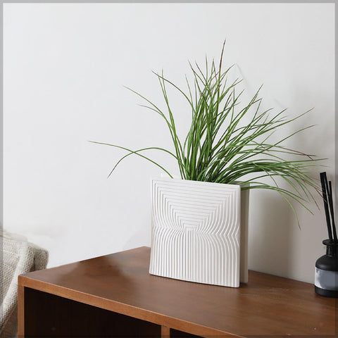 White flower vase with dried floral arrangement