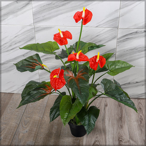 Bright red faux anthurium flowers in stylish indoor setting