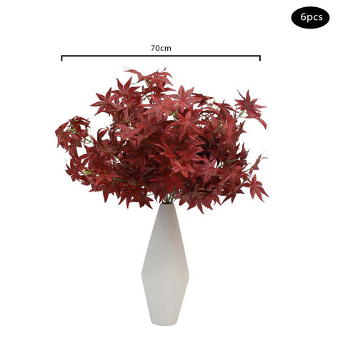 Lifelike artificial red maple leaf branches in a vase