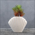 White ceramic vase with shell design