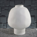 White ceramic vase with footed base