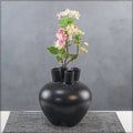 Small black bud vase with elegant round shape