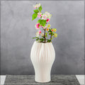 Tall white ceramic vase with star pattern