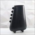 Handmade black ceramic vase with rough surface texture