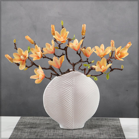 Large white ceramic vase with nature-inspired patterns