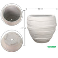 Round white concrete planter with ribbed design