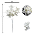 White artificial maple leaves in a vase for modern decor