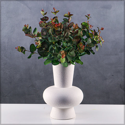 White ceramic vase with a wide opening for floral centerpieces